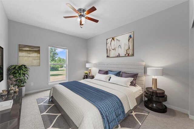 bedroom with ceiling fan and light carpet