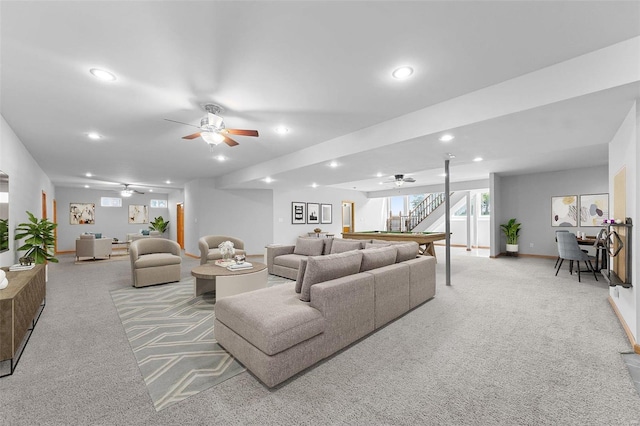 living room with ceiling fan and light colored carpet