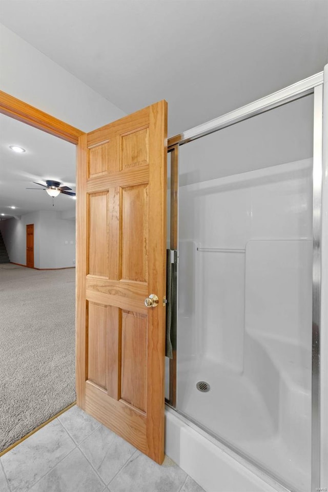 bathroom with ceiling fan, tile patterned floors, and an enclosed shower