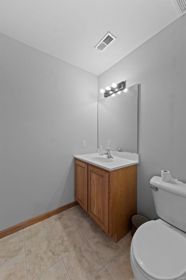 bathroom with vanity, tile patterned flooring, and toilet