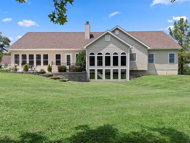 back of house featuring a lawn