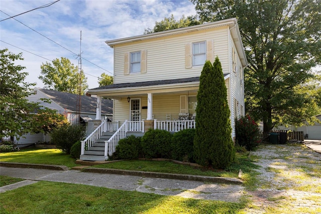 view of front facade with covered porch and a front yard