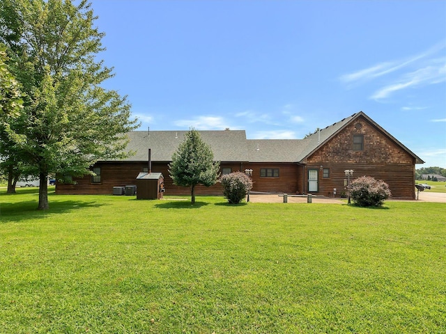 back of house with a yard and a patio area