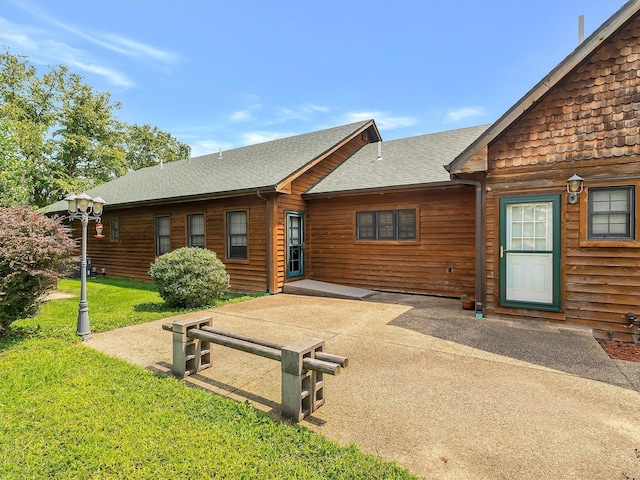 back of house with a patio and a yard