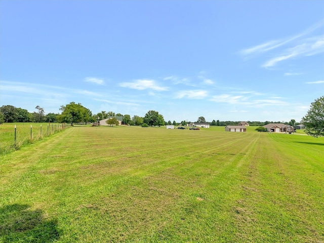 view of yard with a rural view