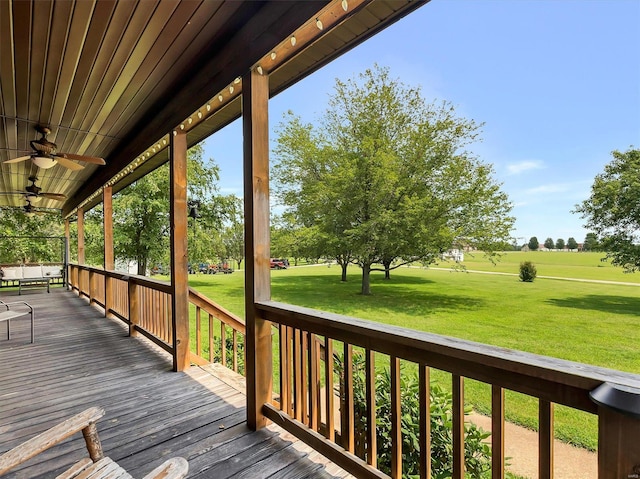 wooden terrace with a yard and ceiling fan