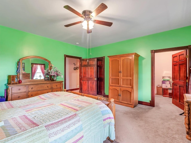 bedroom featuring light colored carpet and ceiling fan