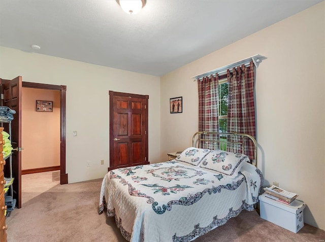 bedroom featuring light colored carpet