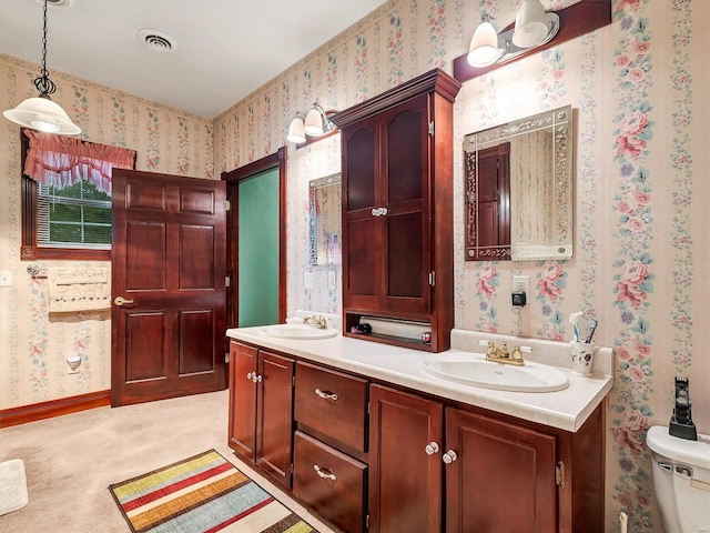 bathroom featuring vanity and toilet