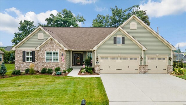 view of front of property featuring a front yard and a garage