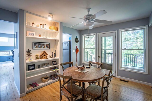 dining area with light hardwood / wood-style flooring and ceiling fan