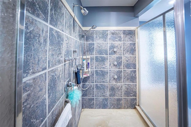 bathroom with a tile shower