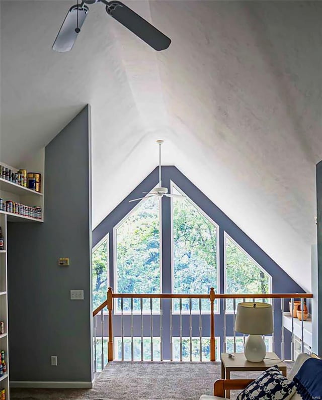 carpeted living room featuring ceiling fan and vaulted ceiling