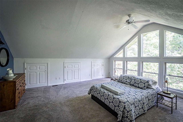 bedroom with multiple windows, lofted ceiling, ceiling fan, and carpet flooring