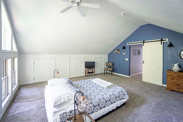 bedroom featuring lofted ceiling, a barn door, ceiling fan, and carpet flooring