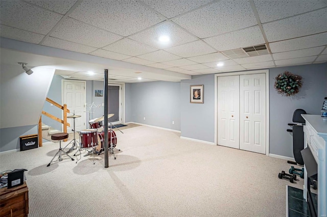 recreation room with a drop ceiling and carpet floors