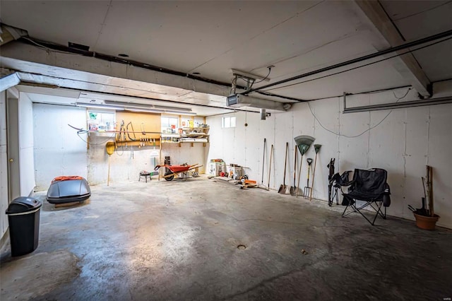 garage featuring a garage door opener and a workshop area