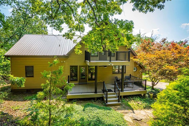 rear view of house with a deck and a balcony