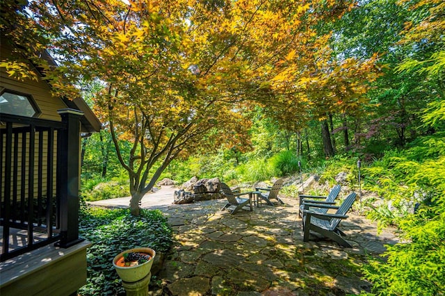 view of yard featuring a fire pit and a patio