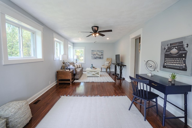 living room with dark hardwood / wood-style floors and ceiling fan