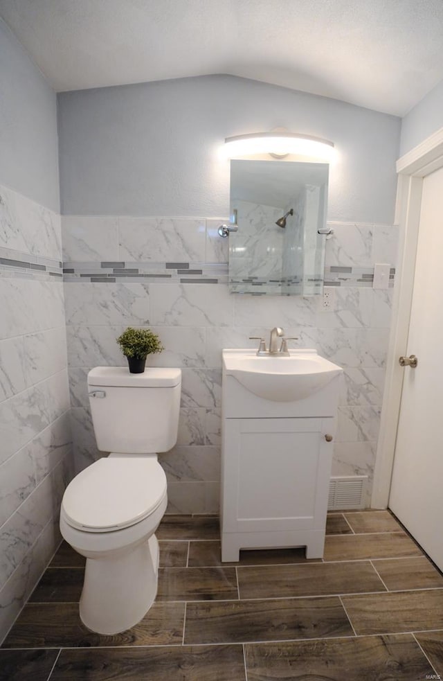 bathroom with vanity, toilet, and walk in shower