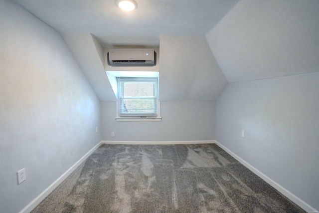 bonus room featuring lofted ceiling, a wall mounted air conditioner, and dark colored carpet