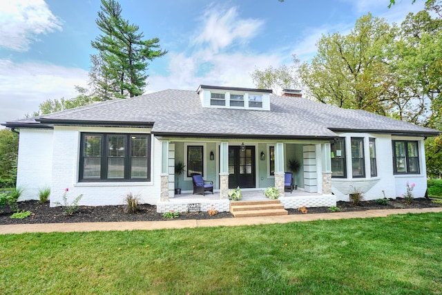 view of front of house featuring covered porch and a front lawn