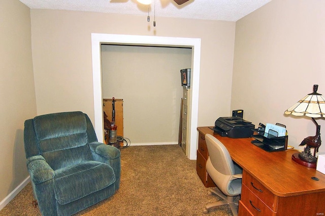 carpeted office space with ceiling fan and a textured ceiling