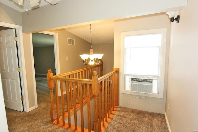 stairs featuring lofted ceiling, carpet flooring, cooling unit, and a chandelier