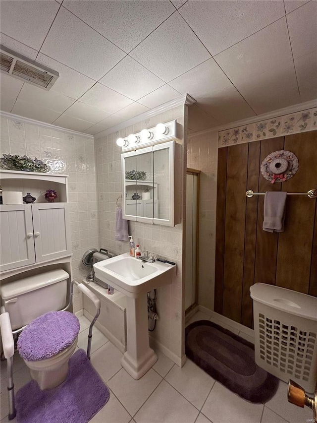 bathroom featuring ornamental molding, tile walls, an enclosed shower, and tile patterned floors