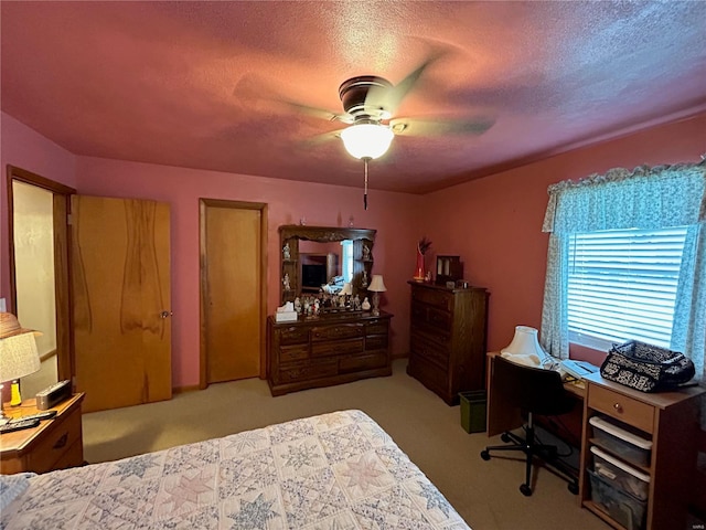 bedroom featuring light carpet, a textured ceiling, and ceiling fan