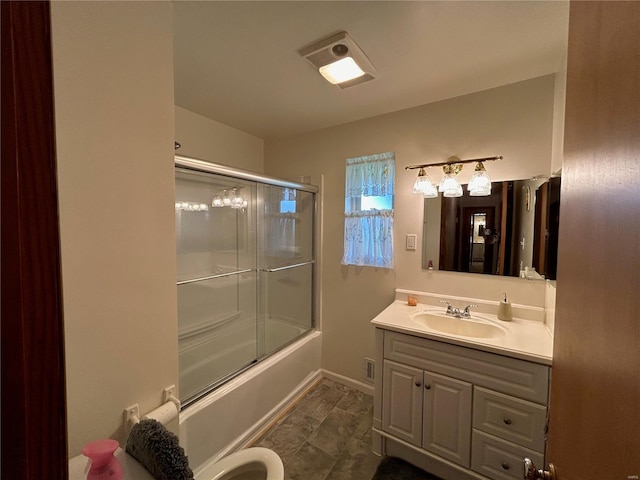 bathroom featuring vanity and bath / shower combo with glass door