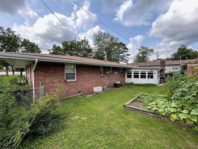 back of house with a lawn