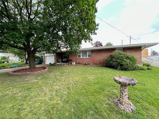 single story home with a garage and a front lawn