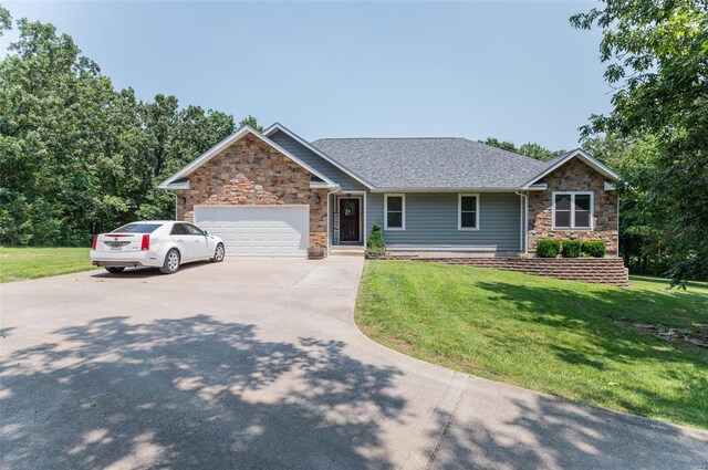 view of front of house featuring a garage and a front lawn