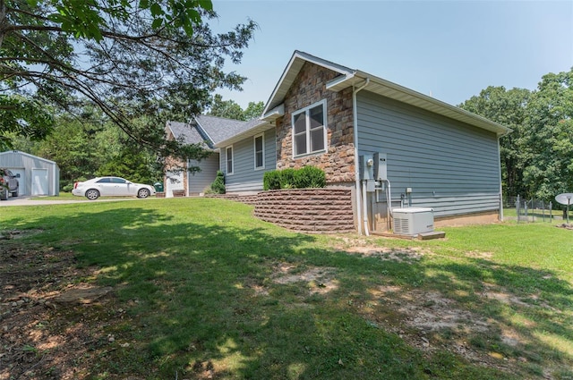 view of side of home featuring a lawn and central AC unit