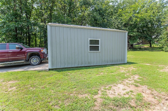 view of outbuilding with a yard