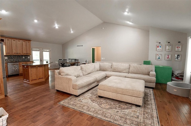 living room with high vaulted ceiling, dark wood-type flooring, and french doors