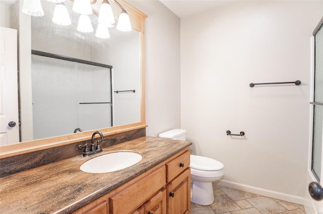 bathroom featuring vanity, tile patterned floors, and toilet