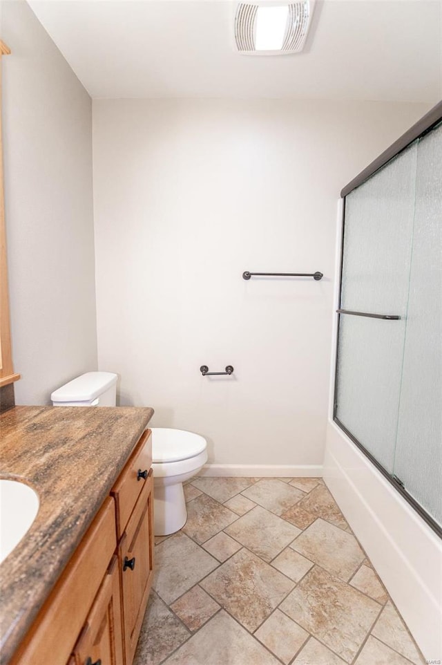 full bathroom featuring tile patterned floors, vanity, combined bath / shower with glass door, and toilet