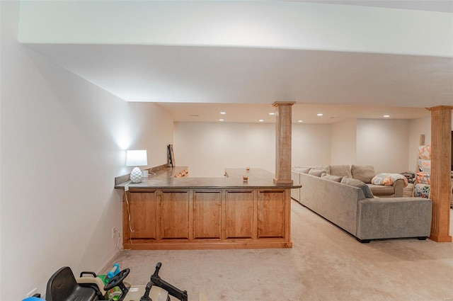 interior space with decorative columns and light colored carpet