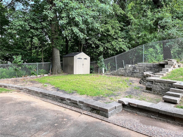 view of yard featuring a shed and a patio area