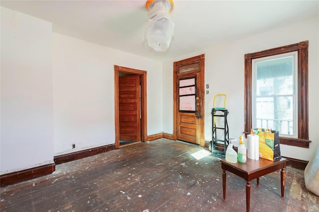 unfurnished living room featuring baseboards