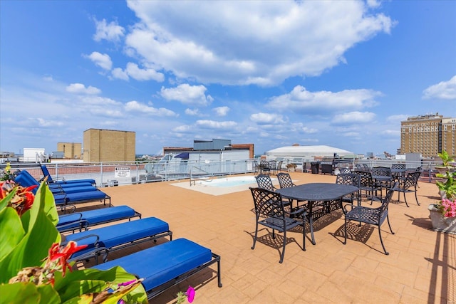 view of patio / terrace with a view of city and outdoor dining area