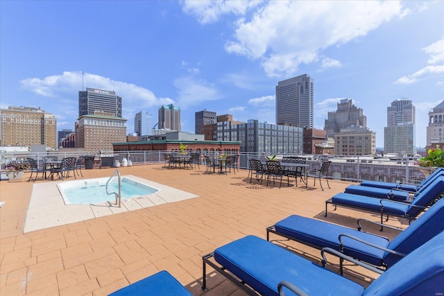 view of pool with a view of city and a patio