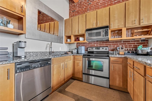 kitchen with stone countertops, stainless steel appliances, brick ceiling, backsplash, and open shelves