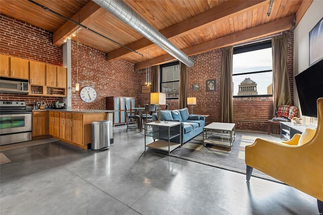 interior space with concrete flooring, beamed ceiling, and brick wall