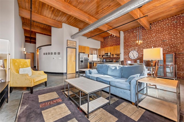 living area with wooden ceiling, brick wall, a high ceiling, and finished concrete floors