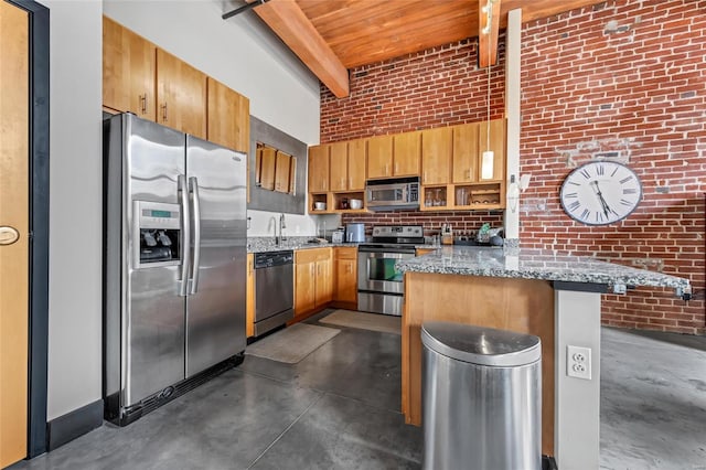 kitchen with beam ceiling, appliances with stainless steel finishes, a sink, brick wall, and concrete flooring