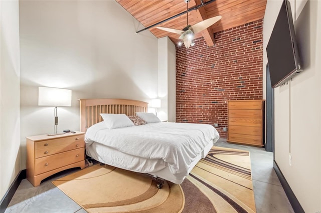 bedroom featuring wooden ceiling, baseboards, beamed ceiling, and brick wall